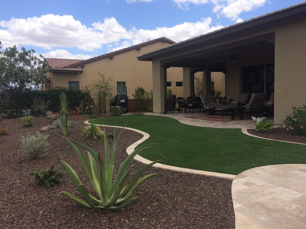 Back full sun garden in Phoenix with a desert look and natural stone paving.