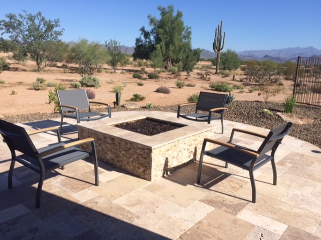 Photo of a classic back patio in Phoenix with natural stone paving and a fire feature.