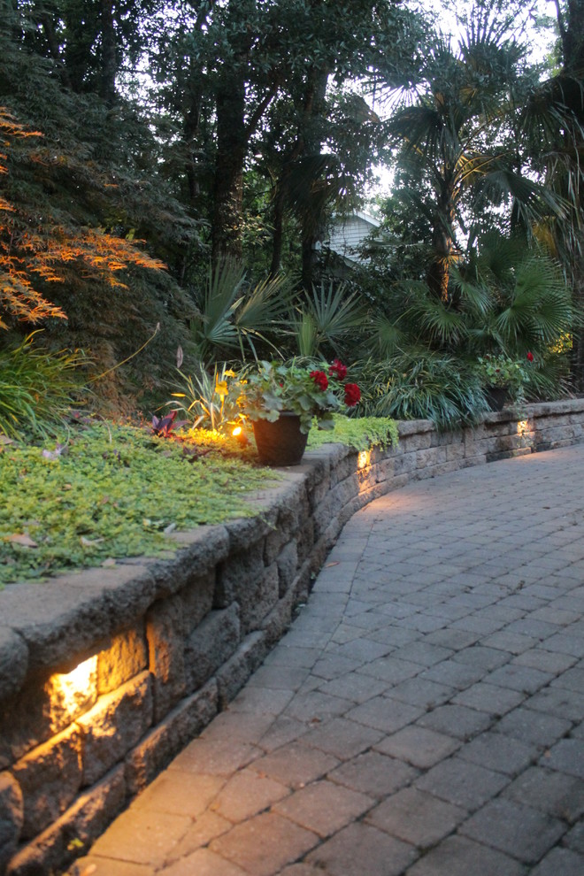 This is an example of a medium sized nautical front driveway garden in Other with a water feature and concrete paving.