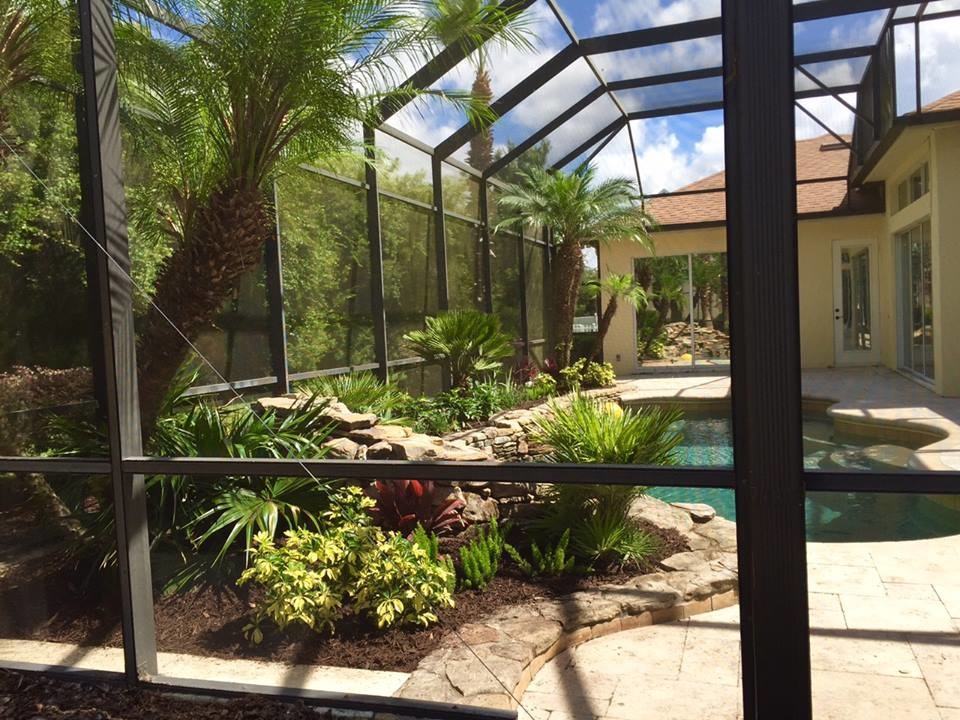 This is an example of a large world-inspired back formal full sun garden in Orlando with a garden path and brick paving.