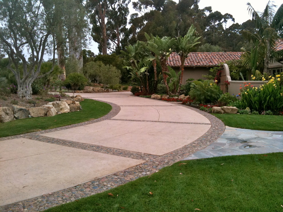 Photo of a mediterranean front yard concrete paver driveway in San Diego.