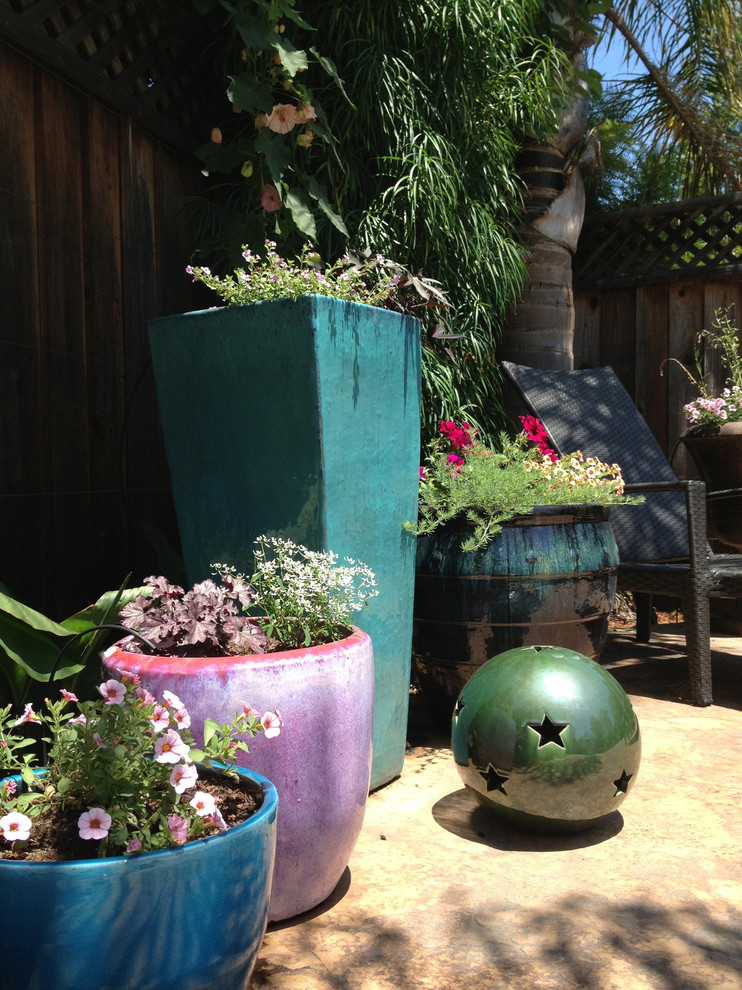Inspiration for a mid-sized tropical partial sun backyard stone formal garden in San Francisco.