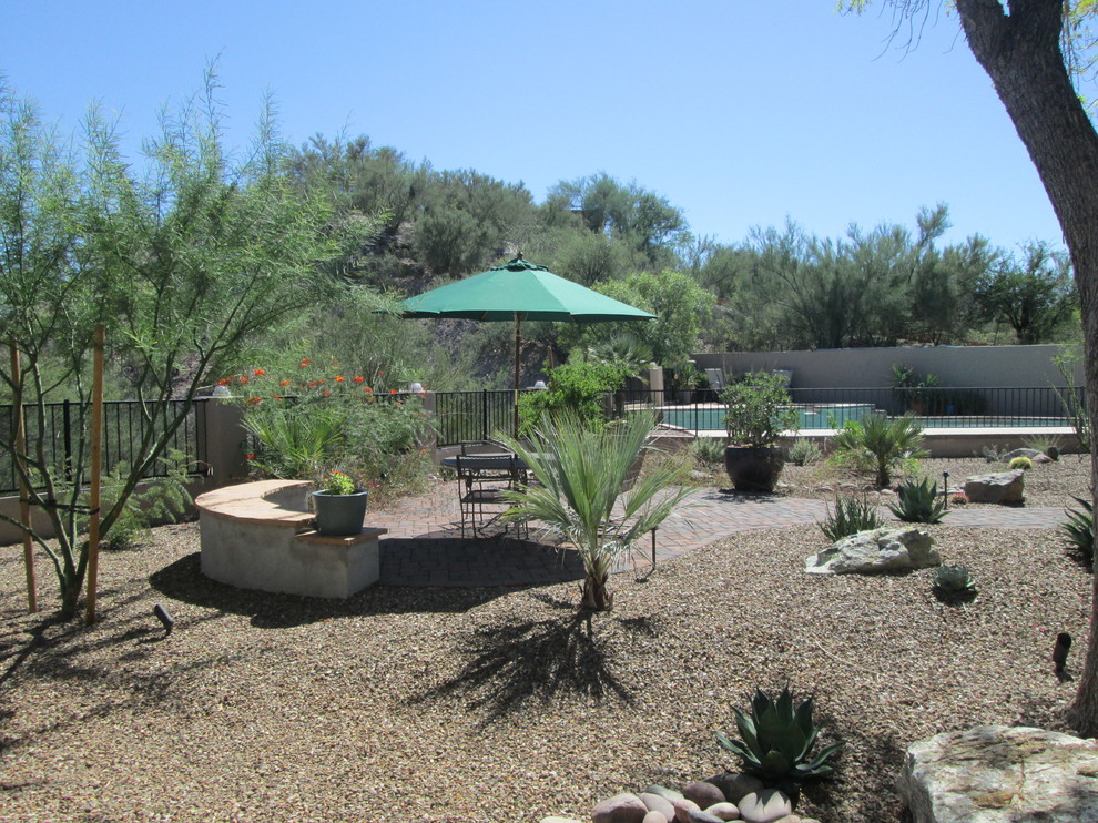 Inspiration for a mid-sized mediterranean drought-tolerant and full sun backyard gravel garden path in Phoenix for summer.