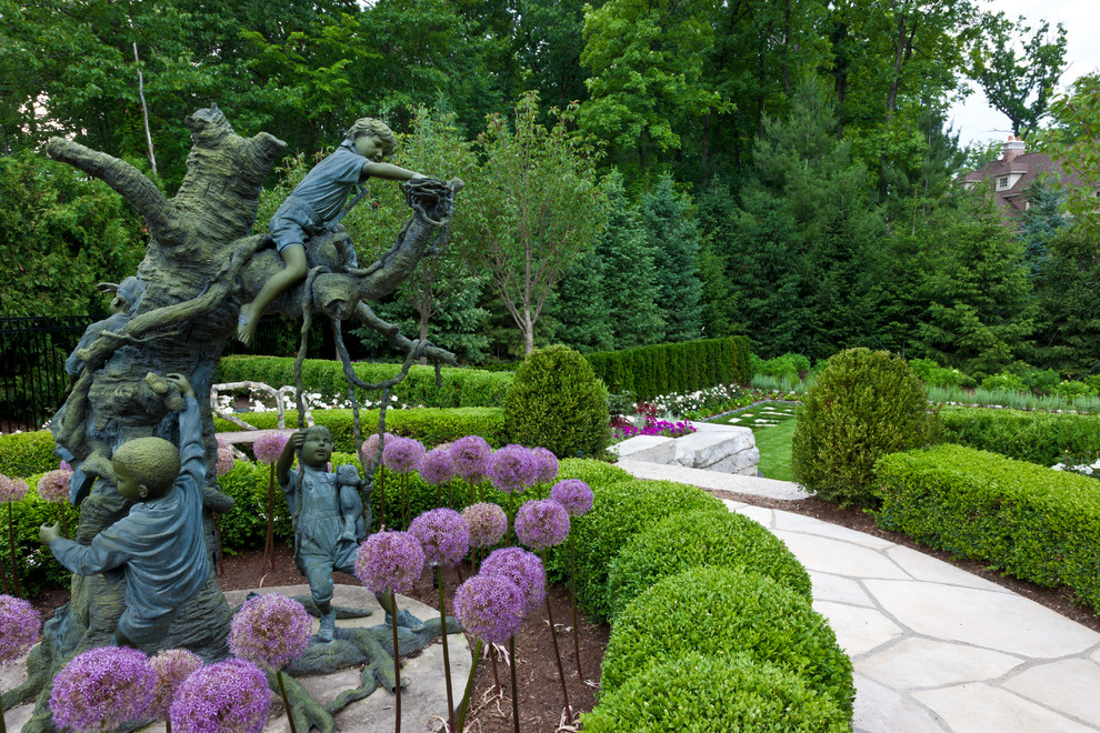 This is an example of a large transitional side yard stone formal garden in Detroit.