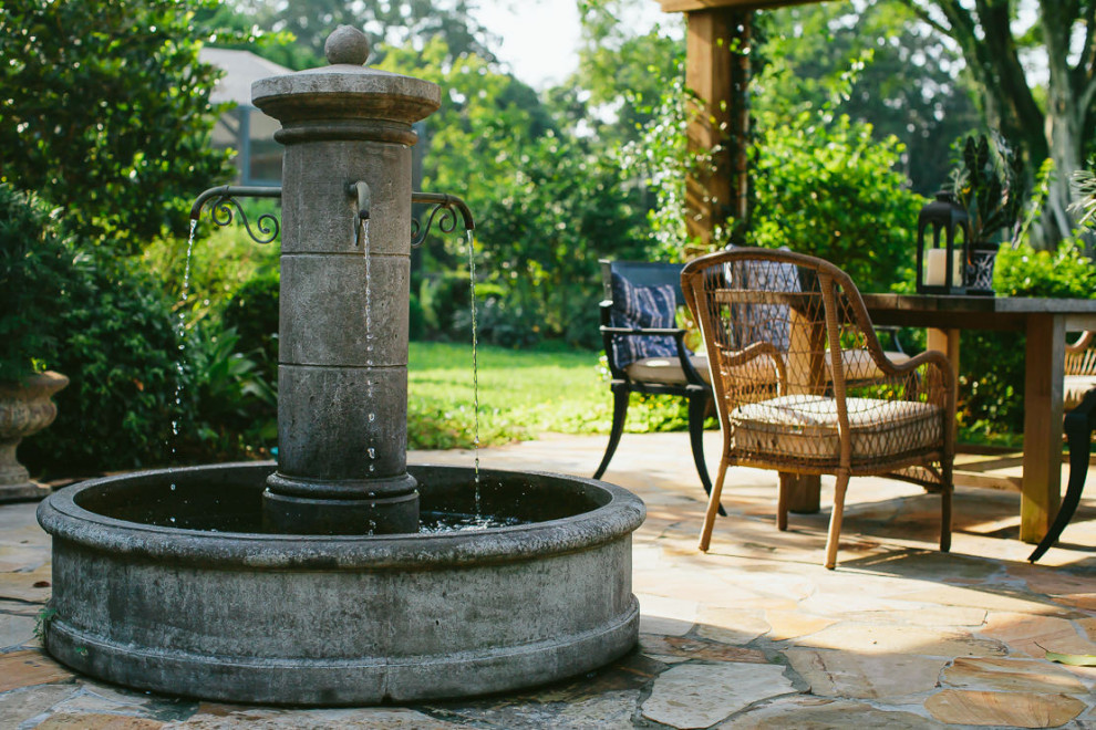 Inspiration for a large farmhouse courtyard stone water fountain landscape in Miami.