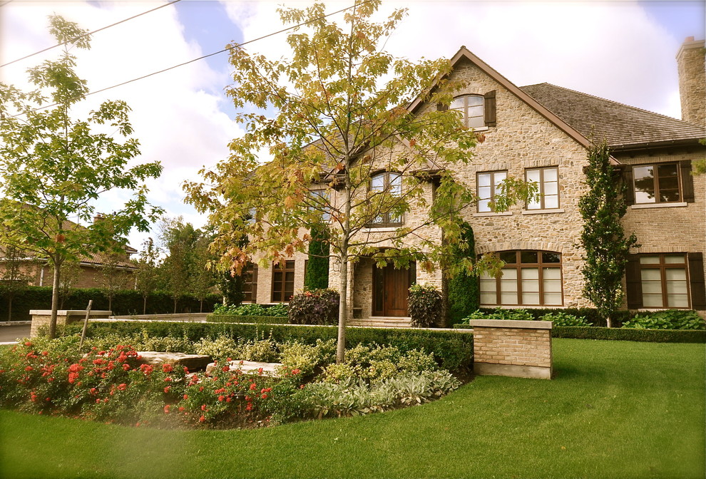 This is an example of a mid-sized mediterranean full sun front yard stone landscaping in Toronto.