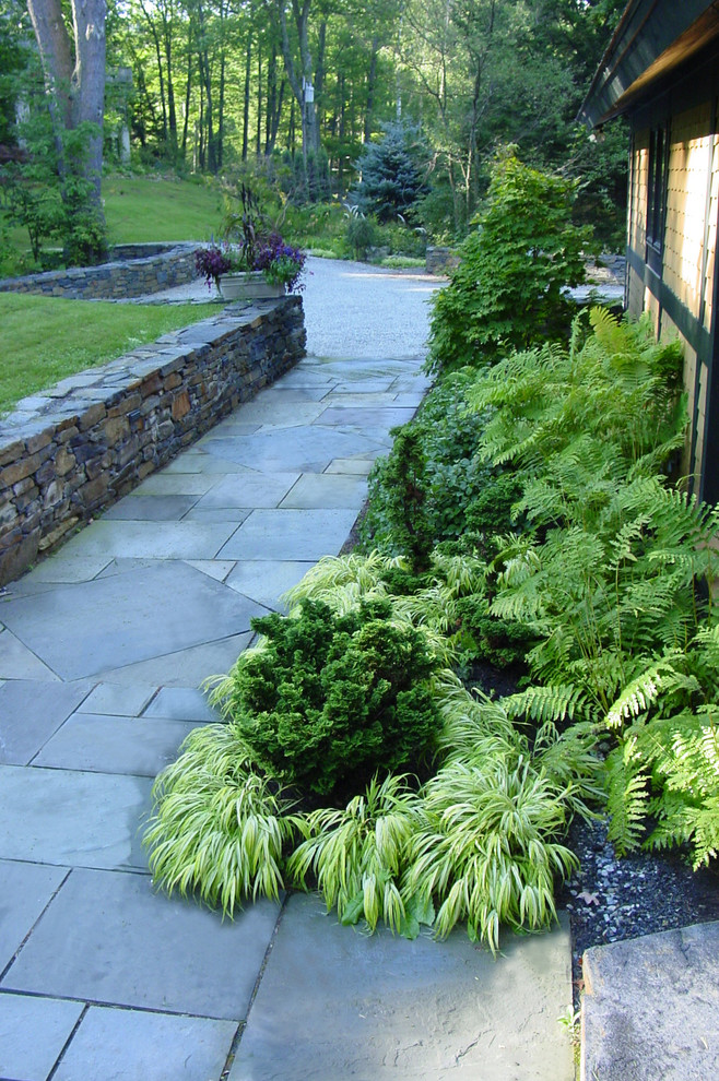 This is an example of a medium sized traditional front fully shaded garden for spring in Boston with a garden path and natural stone paving.