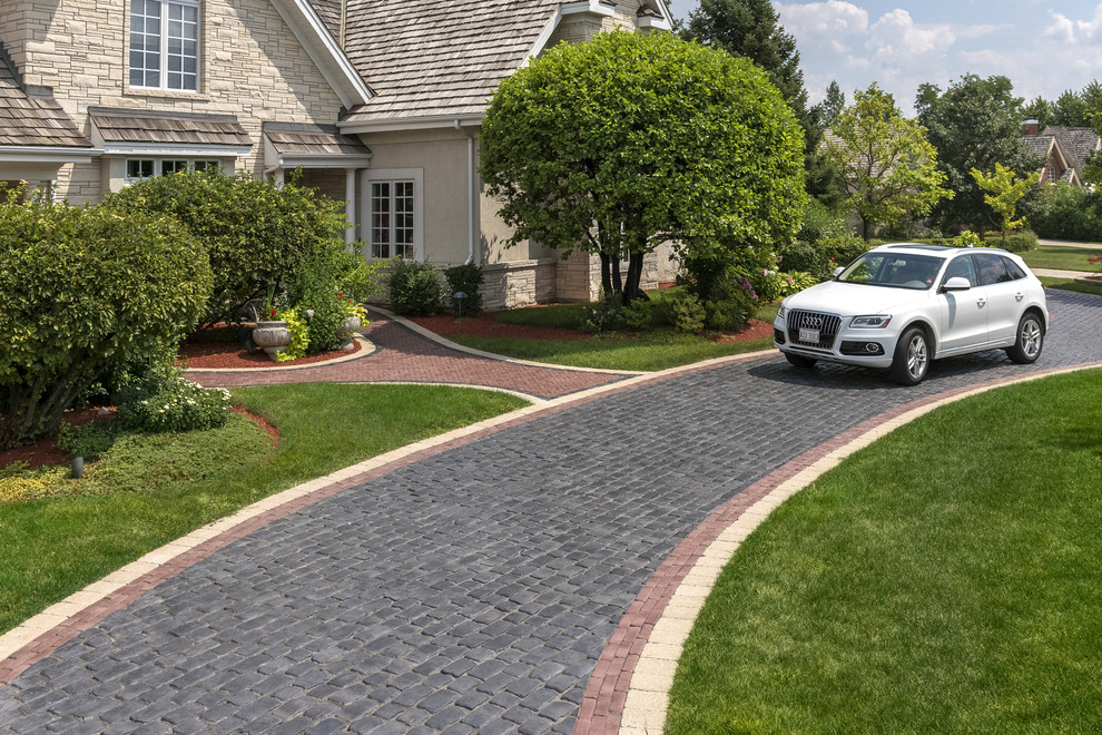 This is an example of a contemporary front yard concrete paver driveway in Other.