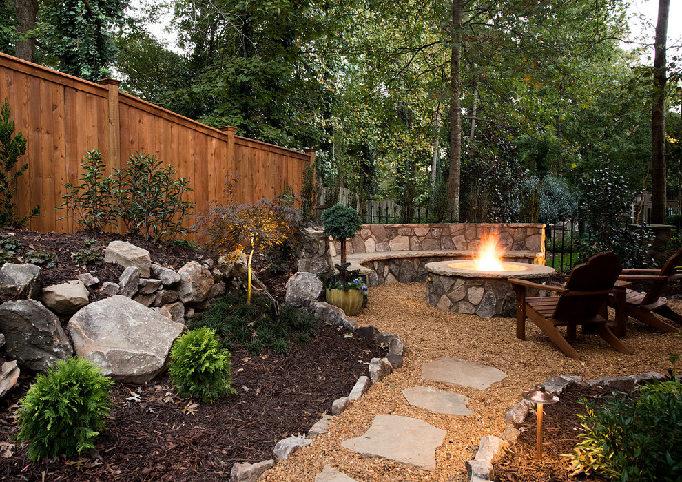 Inspiration for a rustic back full sun garden in Atlanta with a fire feature and gravel.