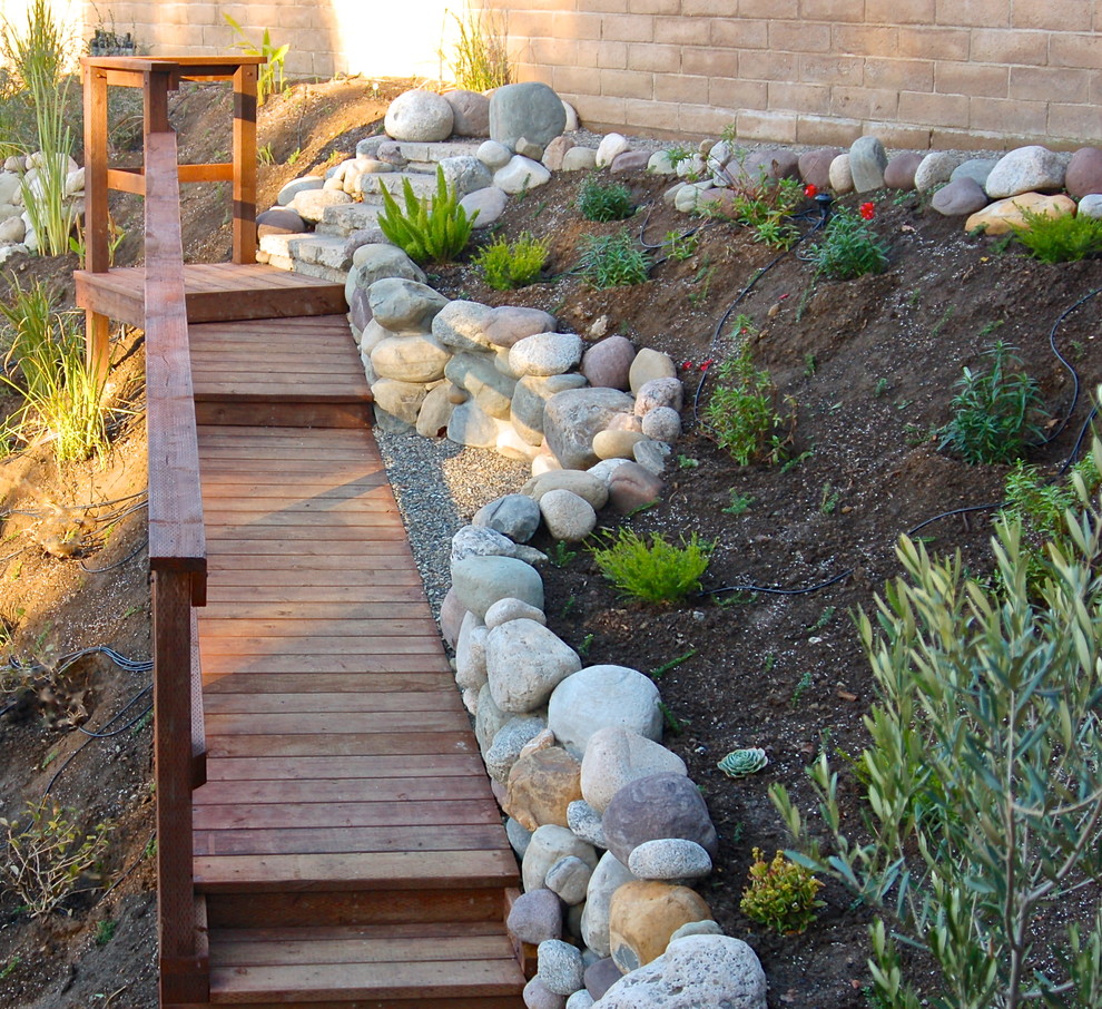 Design ideas for a large classic sloped xeriscape full sun garden for spring in Los Angeles with a garden path and decking.
