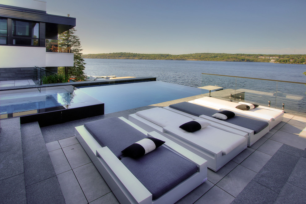 Design ideas for a large modern garden in Toronto with concrete paving.
