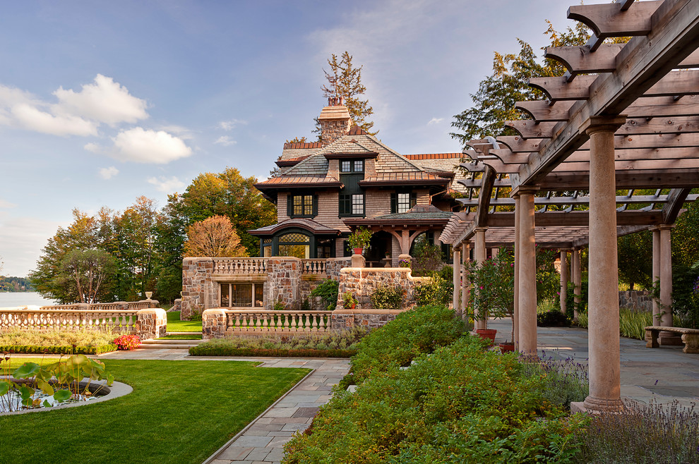 Inspiration for a huge victorian courtyard stone landscaping in New York.