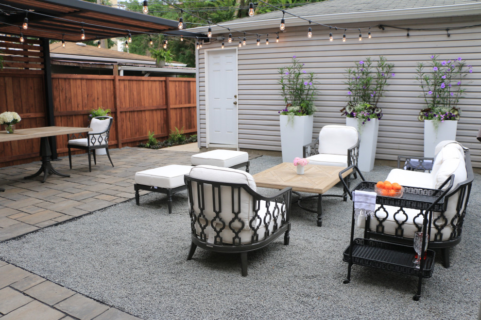 Small contemporary back patio in Chicago with a potted garden and natural stone paving.