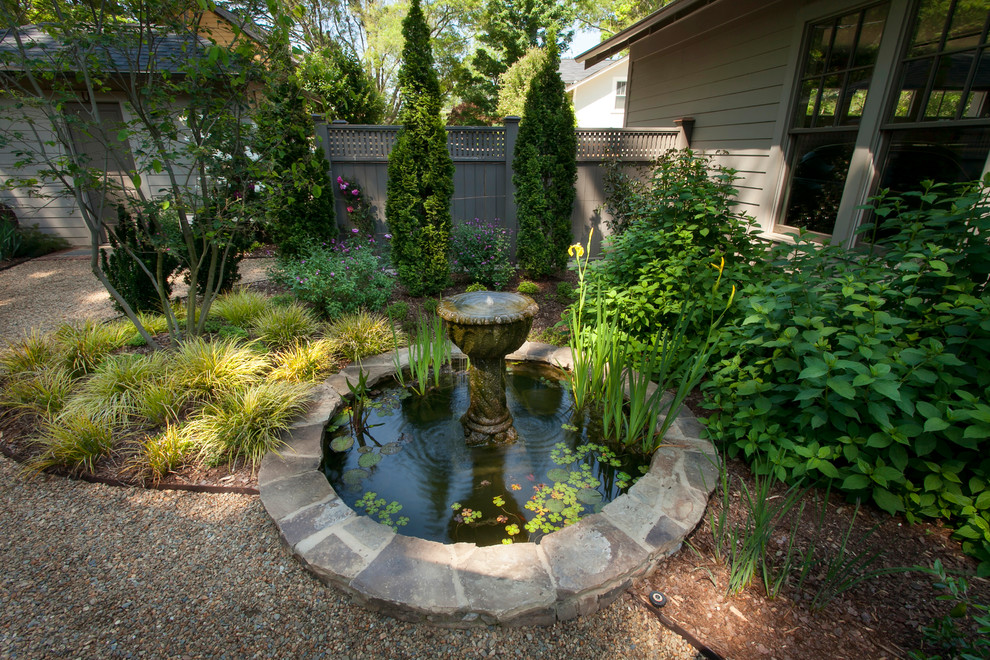 Design ideas for a traditional garden in Charlotte with a water feature.