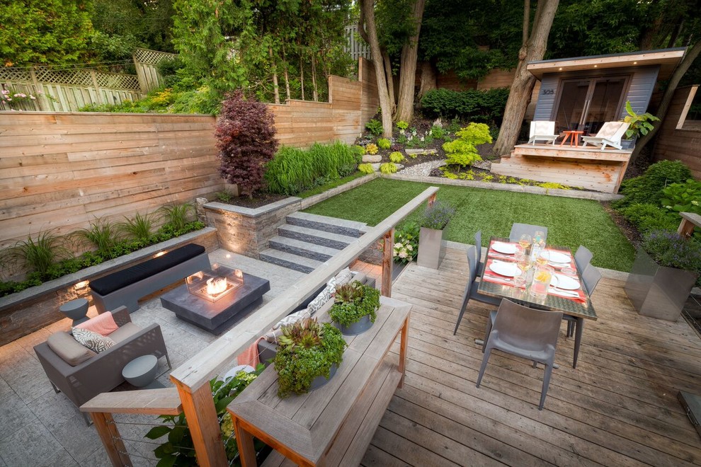 Photo of a small contemporary back garden in Toronto with a fire feature and natural stone paving.