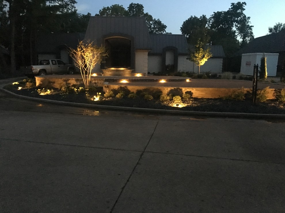 This is an example of a medium sized contemporary front driveway garden in Oklahoma City with concrete paving.