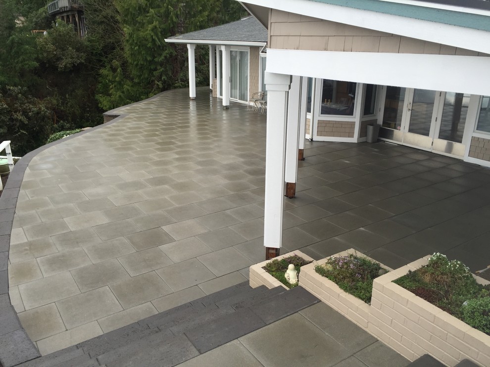 Photo of a large modern back garden in Seattle with concrete paving.
