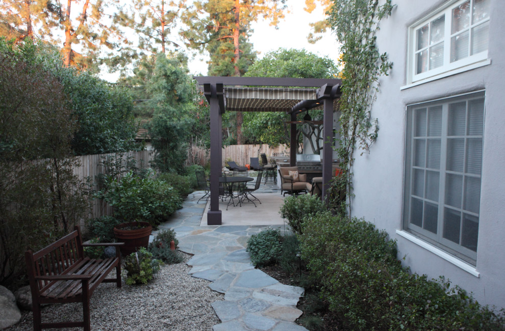 Classic back xeriscape partial sun garden for winter in Los Angeles with natural stone paving.