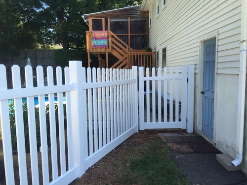 Small fenced in area with a white picket fence