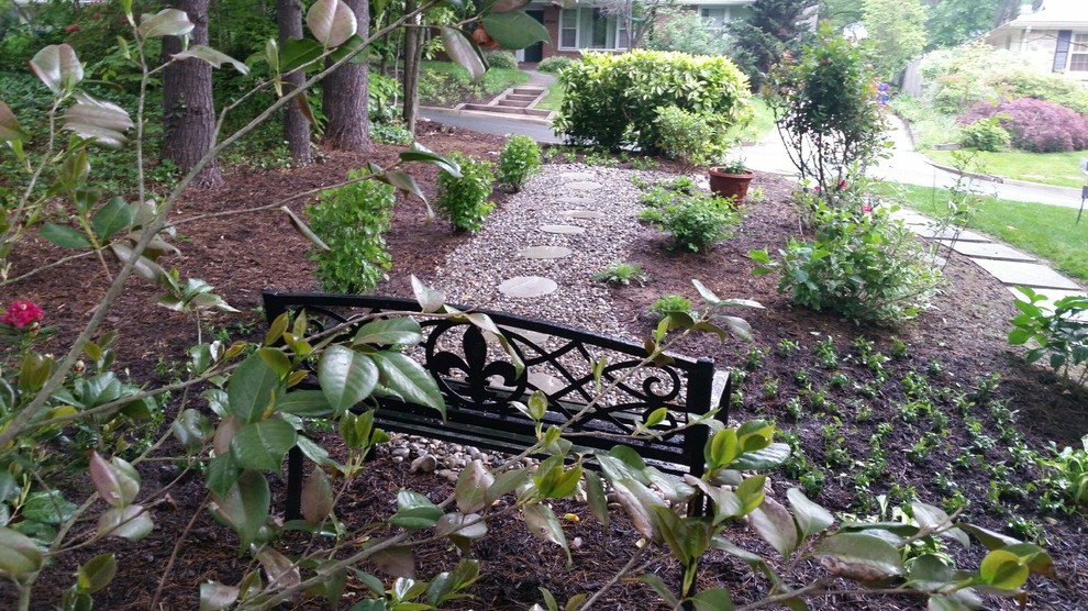 Photo of a small country front formal partial sun garden in DC Metro with a garden path and gravel.