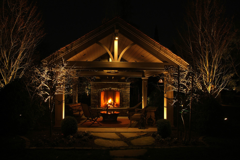 Inspiration for a mid-sized traditional shade backyard concrete paver landscaping in Sacramento with a fire pit.