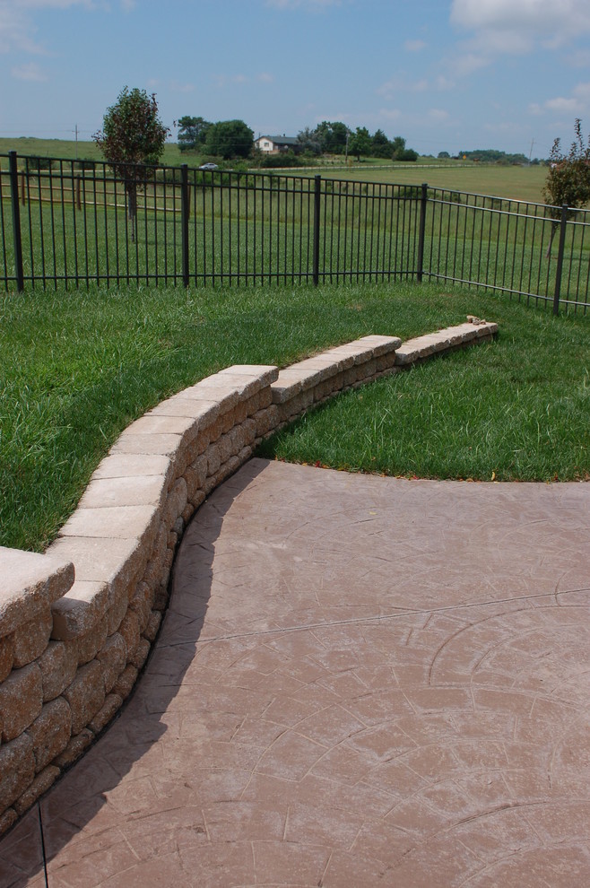 Photo of a huge traditional backyard retaining wall landscape in Other.
