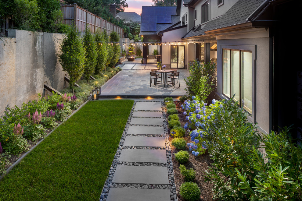 Contemporary back formal partial sun garden for summer in DC Metro with a waterfall and natural stone paving.