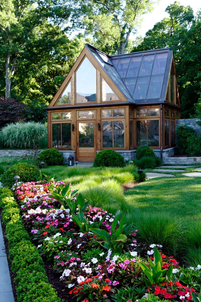 This is an example of a large classic formal garden in DC Metro with concrete paving and a flowerbed.