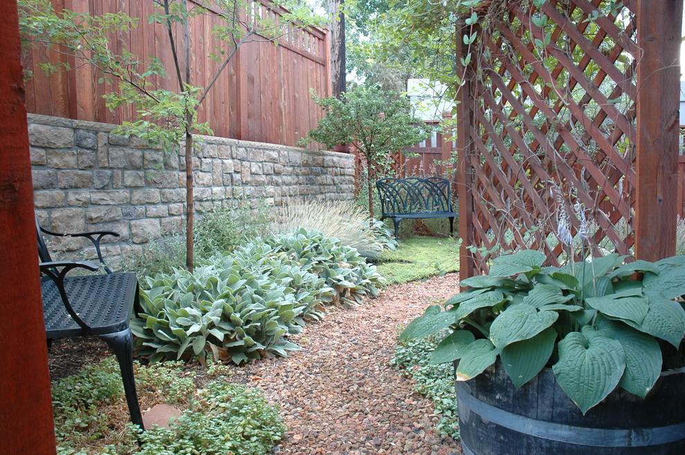 Design ideas for a small eclectic drought-tolerant and full sun backyard retaining wall landscape in Salt Lake City for summer.