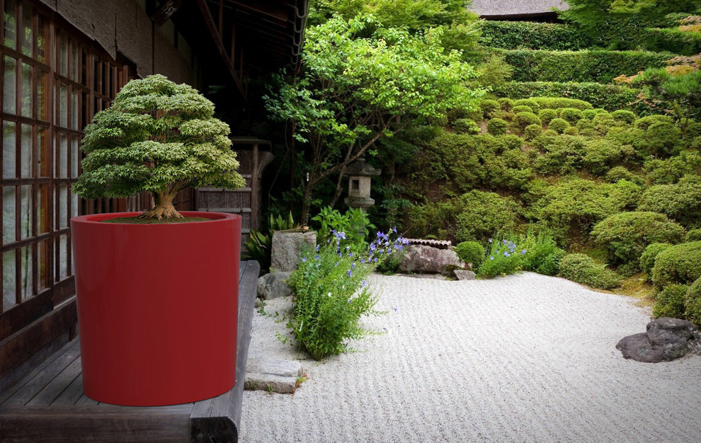 This is an example of a large contemporary partial sun backyard concrete paver formal garden in Toronto for summer.