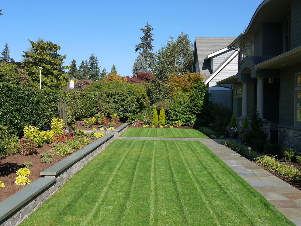 Immagine di un grande giardino moderno esposto a mezz'ombra davanti casa con pavimentazioni in pietra naturale e un ingresso o sentiero