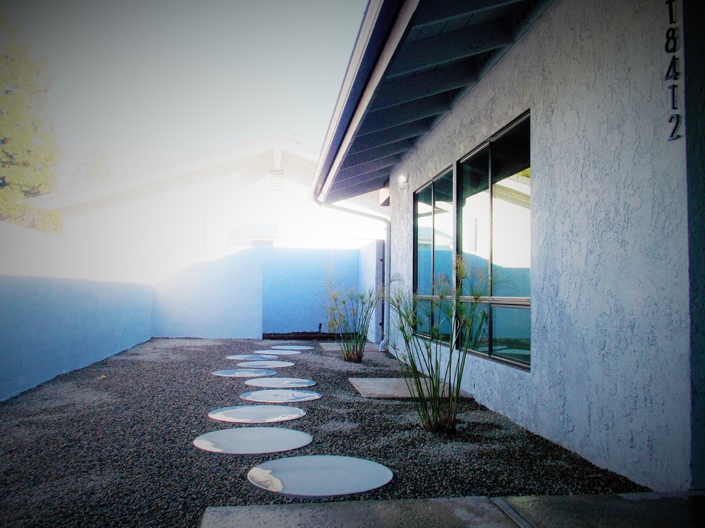 Design ideas for a retro front xeriscape garden in Orange County with concrete paving.
