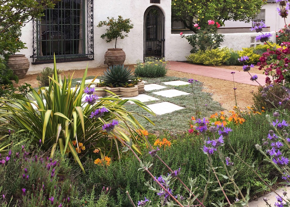 Photo of a mid-sized mediterranean full sun front yard concrete paver landscaping in Los Angeles for spring.