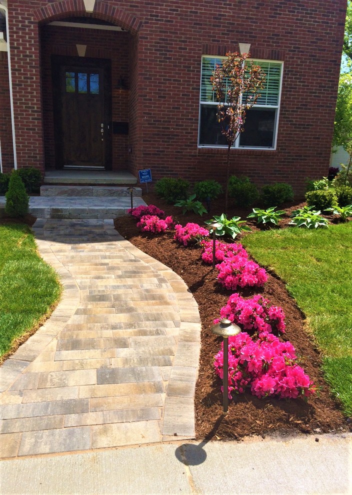 Photo of a mid-sized modern partial sun front yard brick landscaping in Detroit.