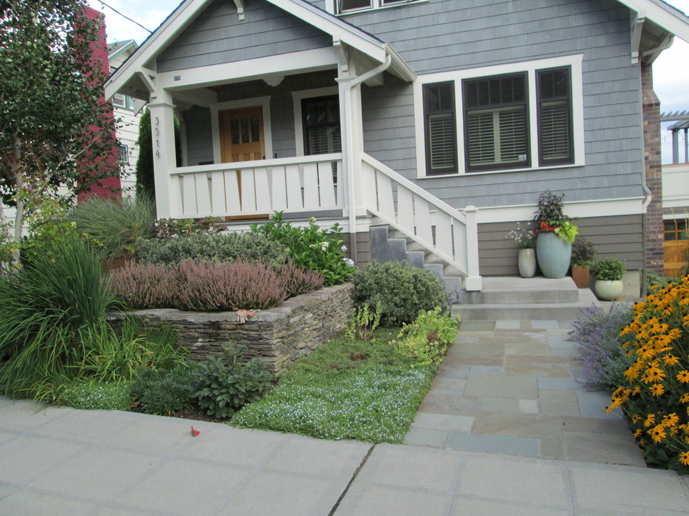 Design ideas for a mid-sized craftsman full sun front yard stone garden path in Seattle.