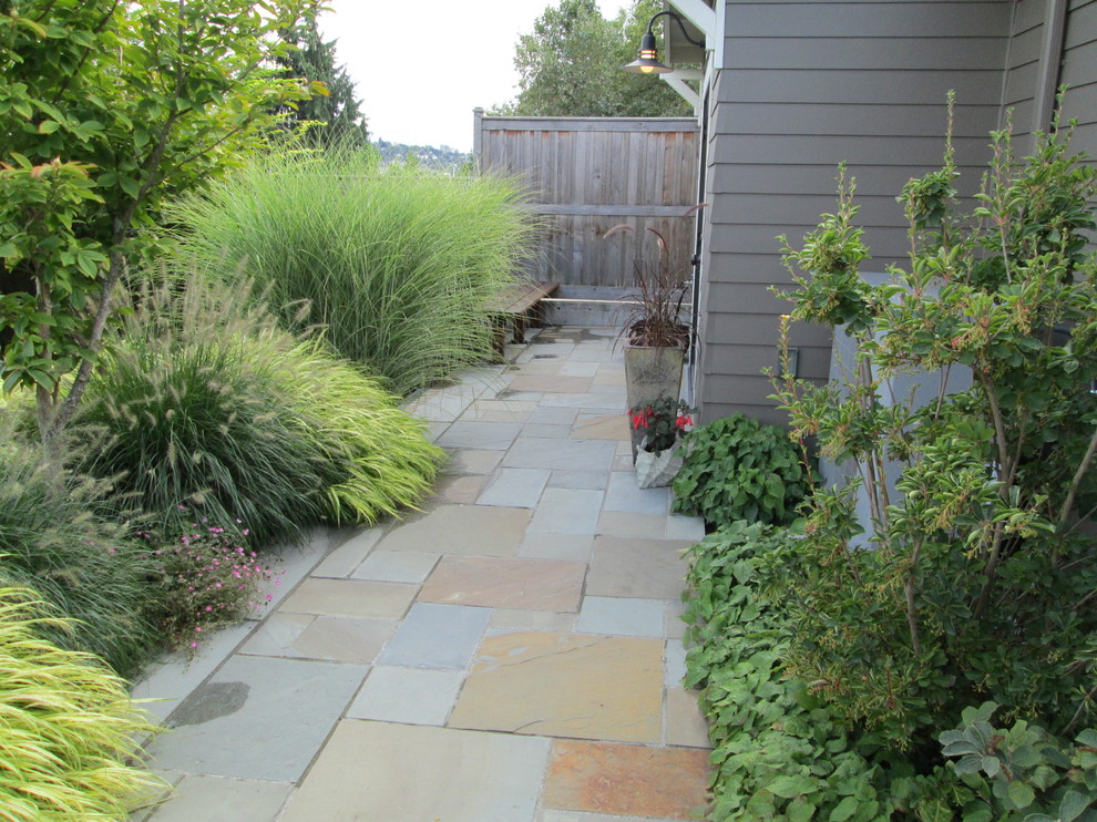 Design ideas for a medium sized traditional back partial sun garden in Seattle with a garden path and natural stone paving.