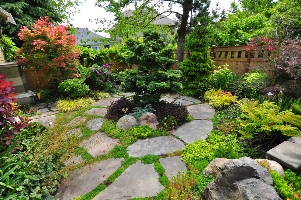 Imagen de jardín de estilo americano grande en patio trasero con brasero y adoquines de ladrillo
