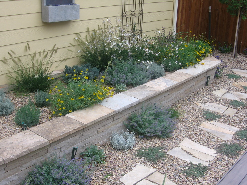 This is an example of a backyard stone retaining wall landscape in Denver.