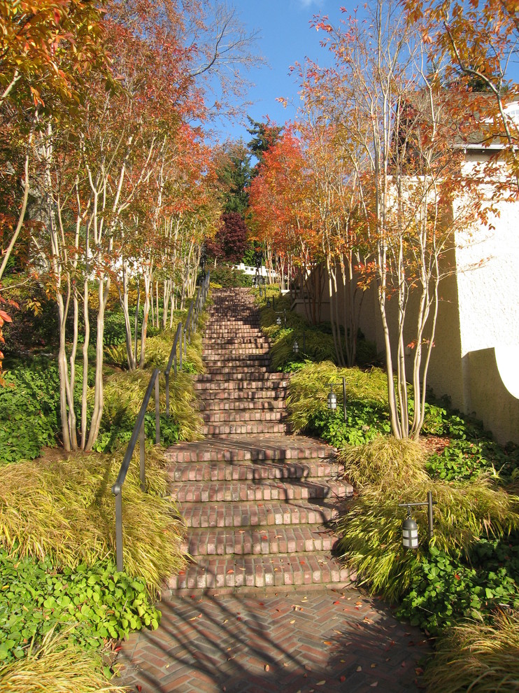 Photo of a large traditional hillside brick garden path in Seattle for fall.