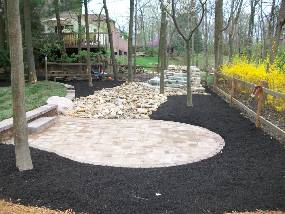 Water Feature and Patio in The Woods at Josephenum Rustic Landscape Columbus by Pony