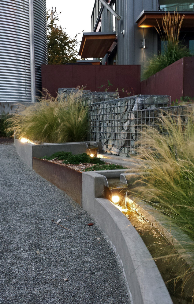 Design ideas for a modern garden in Seattle with a water feature.