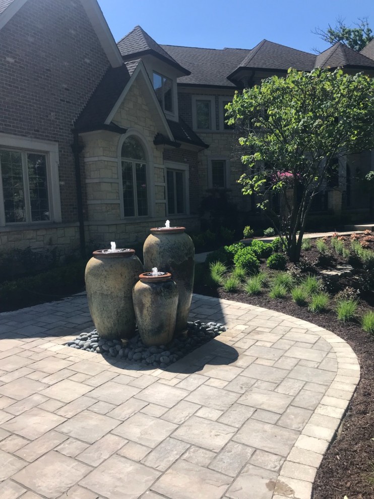 Inspiration for a large front garden in Chicago with a water feature and brick paving.