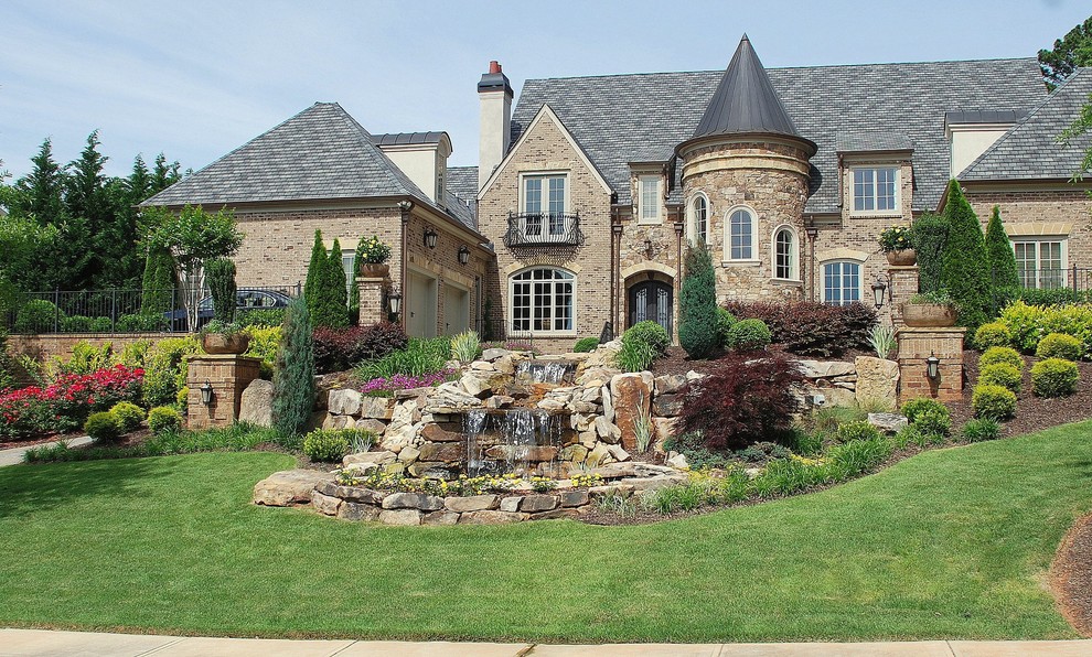 This is an example of a large traditional front yard water fountain landscape in Atlanta.