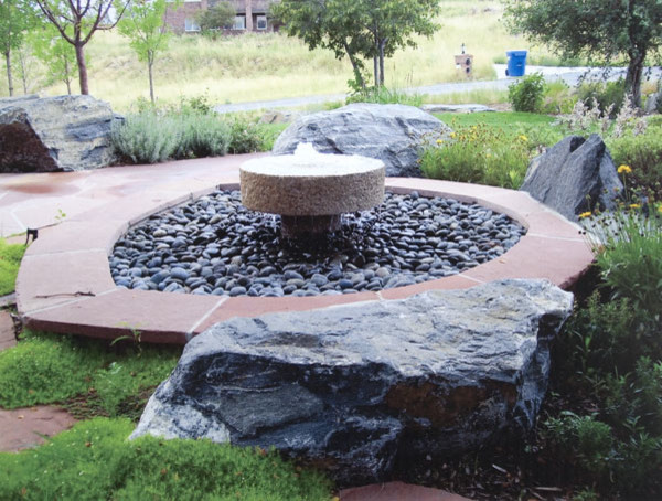 Design ideas for a medium sized traditional back full sun garden in Denver with a water feature and brick paving.