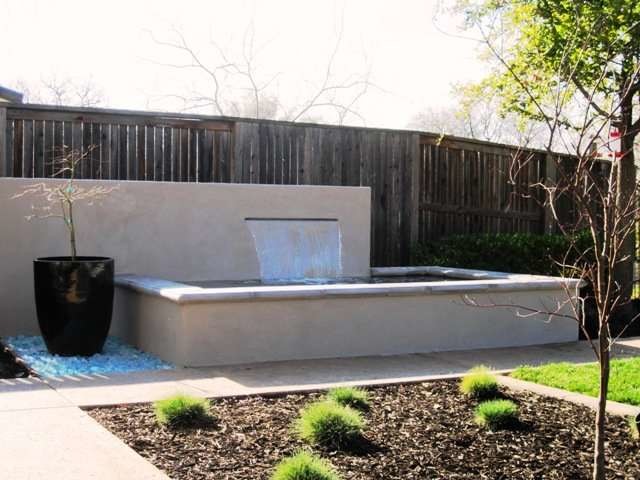Inspiration for a large contemporary back formal partial sun raised pond in Sacramento with a water feature and natural stone paving.