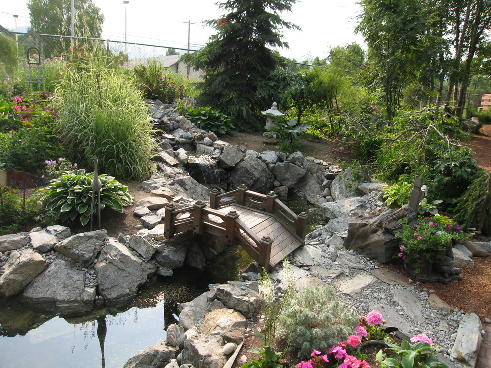 Design ideas for a large classic back full sun garden in Other with a pond.