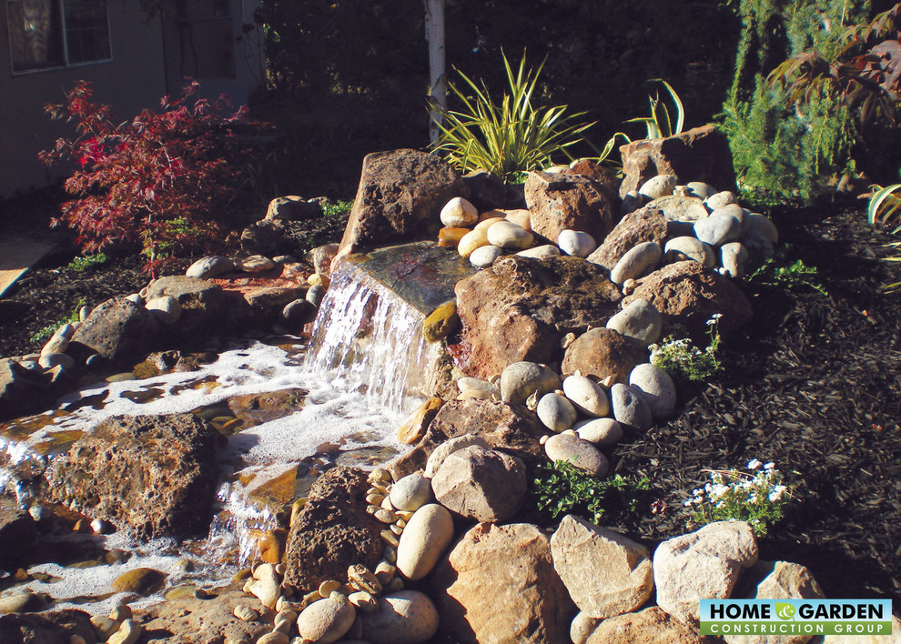 Photo of a mediterranean back garden in San Francisco with a water feature.