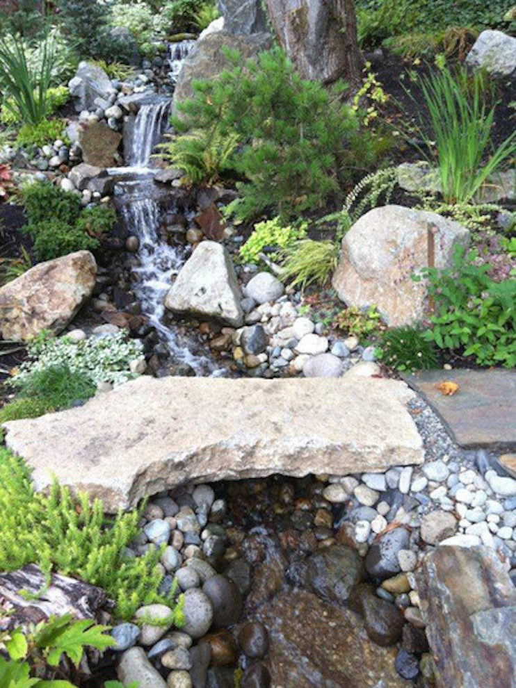 Design ideas for a mid-sized asian full sun backyard stone landscaping in Seattle for fall.