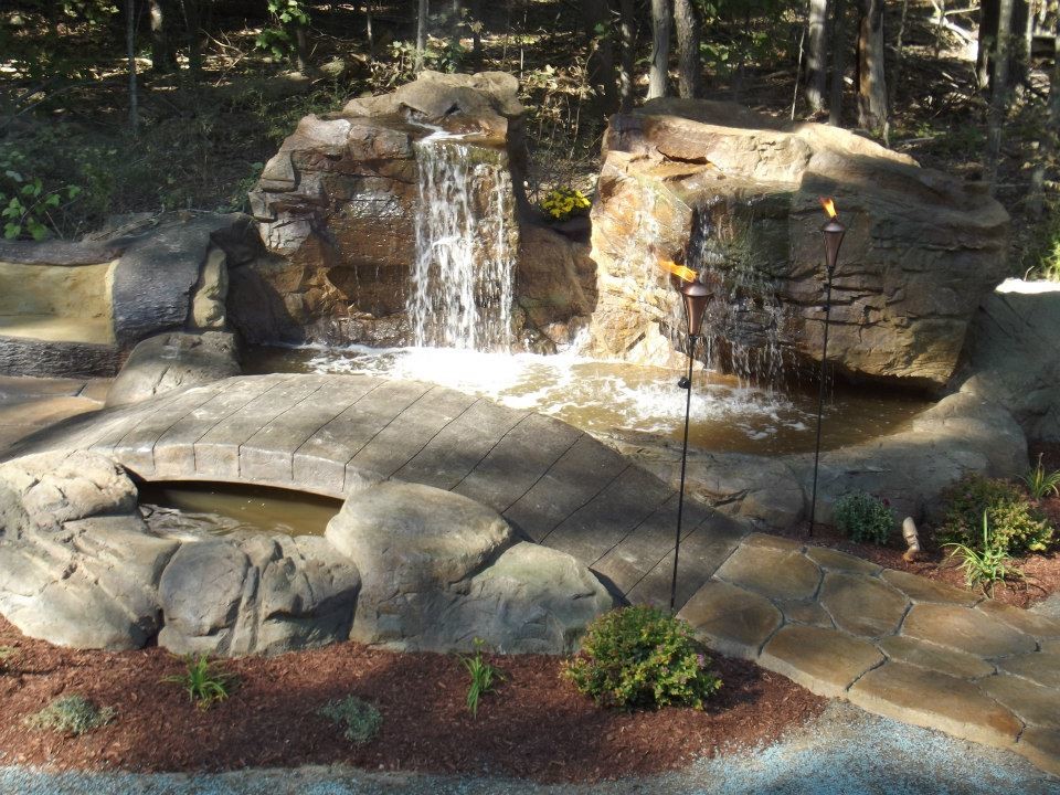 This is an example of a rustic raised pond in Jacksonville.