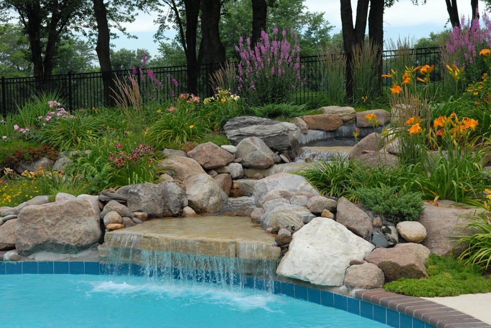 This is an example of a contemporary garden in Other with a water feature.